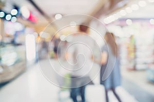 People shopping in department store. Defocused blur background