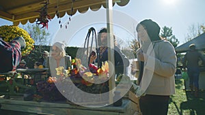 People shopping at farmers market outdoors