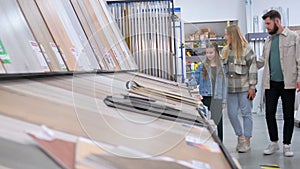 People shopping for flooring in a building store for their house