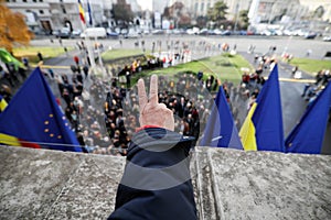 People show the Victory Sign from the balcony where Nicolae Ceausescu held his last speech during the Romanian anti communist