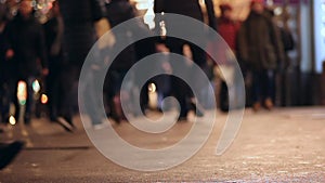 People on sidewalk. Crowded crosswalk. City life. Evening. Legs. Asphalt.