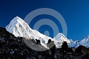 People silhouette hiking in mountains