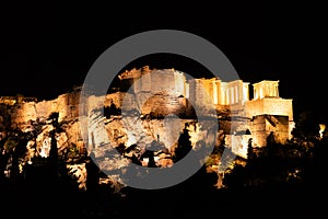 People silhouettes in the foreground, with Acropolis night view at the background