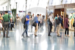 People silhouettes in motion blur, airport interior