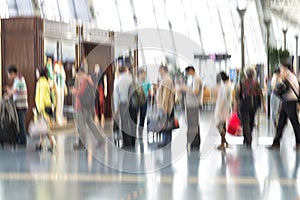 People silhouettes in motion blur, airport interior