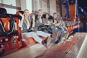 People are sitting on an attraction bench.