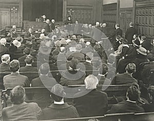 People sitting on benches in courtroom photo