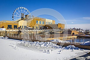 People are sitting in cafe and swimming in pool in cold winter day at spa complex in Helsinki, Finland.