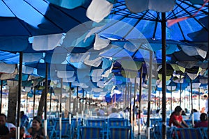 People sitting on chair for relaxing and eating under umbrella beach