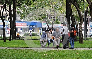 People sitting and chatting at the city park in Saigon, Vietnam