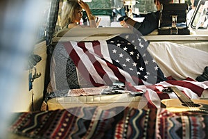 People Sitting in a Front Seat with American Flag on Rear Seat