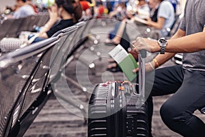 People sitting and waiting for check in at airport. A man and luggage at the airport terminal