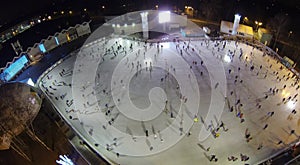 People skate on the rink with artificial ice in