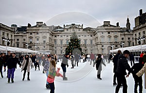 People skating on ice at the Somerset House Christmas Ice Rink. London, United Kingdom, December 2018.