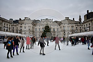 People skating on ice at the Somerset House Christmas Ice Rink. London, United Kingdom, December 2018.