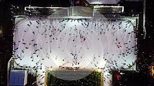 People skating on open-air ice. New Year Christmas celebration illuminations.