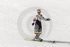 People skiing dressed with traditional bulgarian clothes.