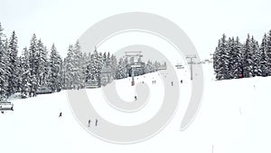 People skiing and snowboarding down a ski slope