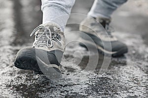 People slides on path. Icing on sidewalk  slippery ice-crusted ground