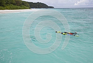 People snorkeling in clear sea water