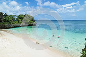People snorkeling in clear turquoise water of a secluded tropical beach, Okinawa, Japan