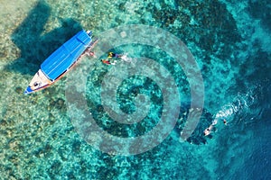 The people are snorkeling near the famous place on Gili Meno Island, Indonesia. Aerial view. Underwater tourism in the ocean. Gili photo