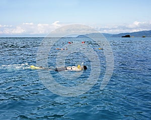 People snorkeling in open blue sea