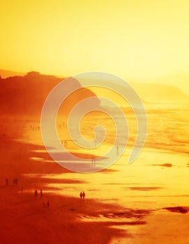 People in Sopelana beach with haze