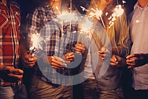People with sparklers on outdoor party photo