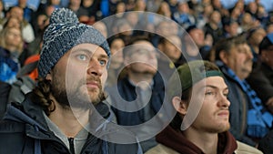 People spectator fan watch game hockey closeup excitedly look match in crowd 4K.