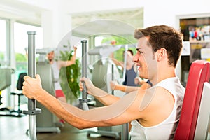 People in sport gym on the fitness machine