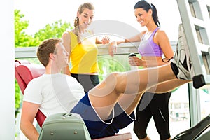 People in sport gym on the fitness machine