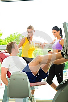 People in sport gym on the fitness machine