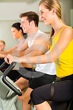 People in sport gym on the fitness machine