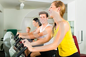 People in sport gym on the fitness machine