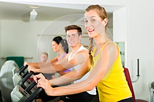 People in sport gym on the fitness machine