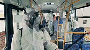 People spray a bus with antiseptics to kill coronavirus.