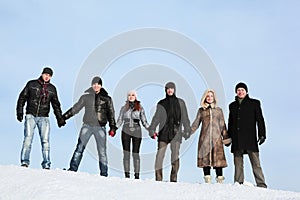 People stand on snow and to hold on to hands