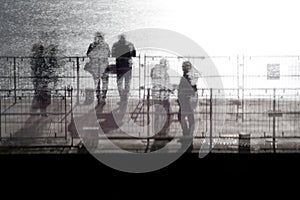 People standing on a pier photo