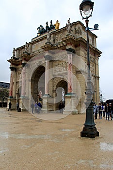 People standing in the rain around The Arc de Triomphe du Carrousel,Paris,France,2016