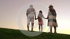 People standing on sunset background.