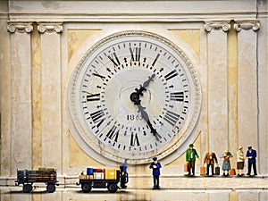 People Station with clock Roman numerals