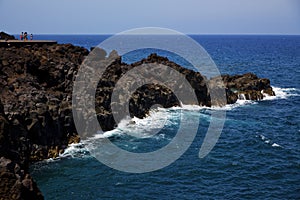 People stone volcanic spain water coast in lanzarote