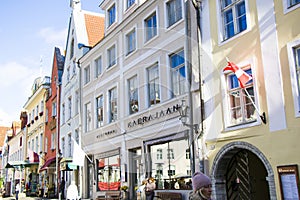 People in the street, tourist walking scene, buildings and architecture exterior view in old town of Tallinn