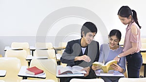 People student read book and talk in lecture chairs classroom