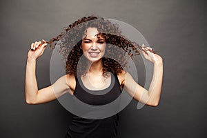 People, style and fashion concept - happy young woman or teen girl in casual clothes having fun.