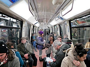 People in subway train wagon interior