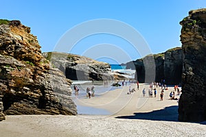 People sunbathing on the idyllic Las Catedrales beach in Galicia Spain