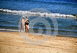 People sunbathing and relaxing in a Sunny day on the beach