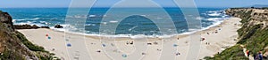 People sunbathing on a sandy beach on the Pacific Ocean coastline